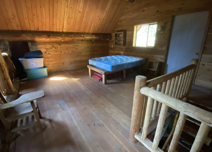 Image of the upstairs room/sleeping loft in the lodge (log cabin/main building).